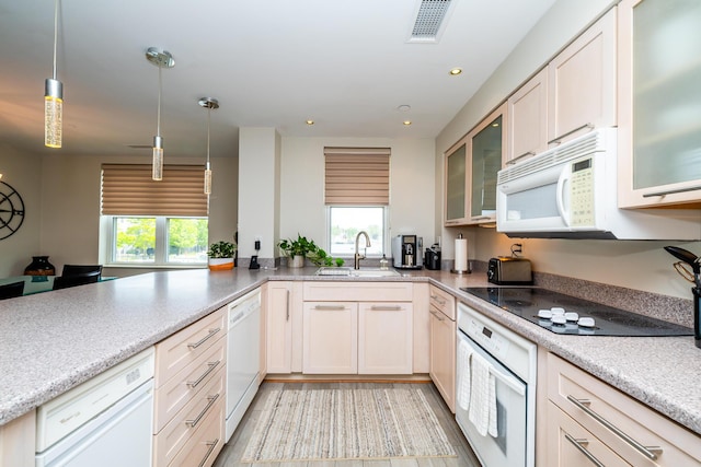 240 Water St Unit 1A, Saint Joseph, MI 49085 - kitchen with a sink, white appliances, hanging light fixtures, glass insert cabinets, and recessed lighting