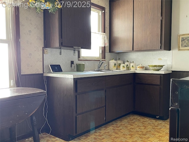 6250 Grandville Ave, Detroit, MI 48228 - kitchen featuring wallpapered walls and light countertops