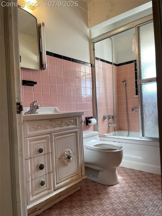 6250 Grandville Ave, Detroit, MI 48228 - full bathroom with tile walls, combined bath / shower with glass door, and vanity