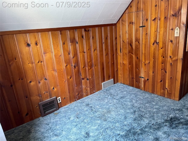 6250 Grandville Ave, Detroit, MI 48228 - bedroom with wooden walls, carpet flooring, and vaulted ceiling