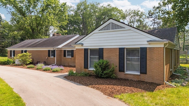 3673 Pheasant Dr, Ann Arbor, MI 48103 - ranch-style house featuring brick siding, a chimney, and a shingled roof