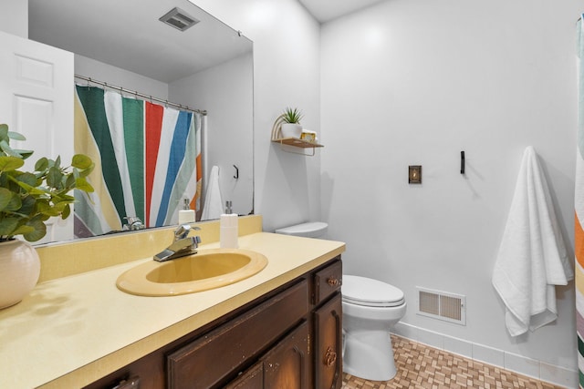 3673 Pheasant Dr, Ann Arbor, MI 48103 - bathroom with toilet, vanity, baseboards, and a shower with shower curtain