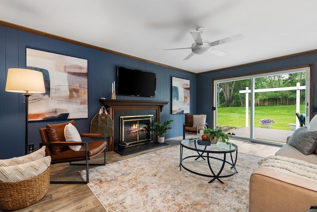 3673 Pheasant Dr, Ann Arbor, MI 48103 - living area featuring wood finished floors, crown molding, a ceiling fan, and a glass covered fireplace