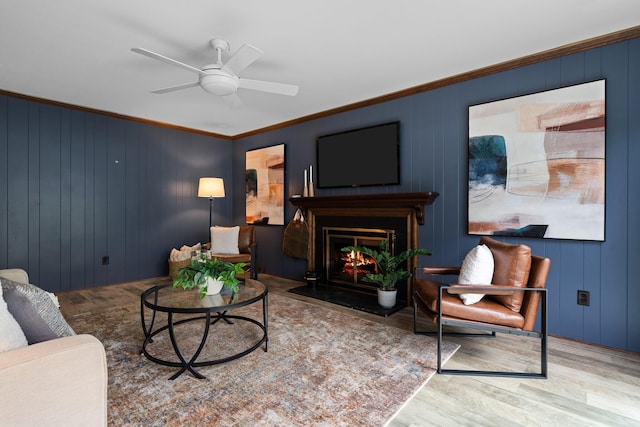 3673 Pheasant Dr, Ann Arbor, MI 48103 - living area featuring wood finished floors, a ceiling fan, a warm lit fireplace, and crown molding