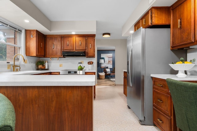 3673 Pheasant Dr, Ann Arbor, MI 48103 - kitchen with ventilation hood, light countertops, tasteful backsplash, stainless steel fridge, and recessed lighting