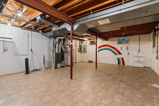 3673 Pheasant Dr, Ann Arbor, MI 48103 - unfinished below grade area featuring heating unit, gas water heater, and tile patterned floors