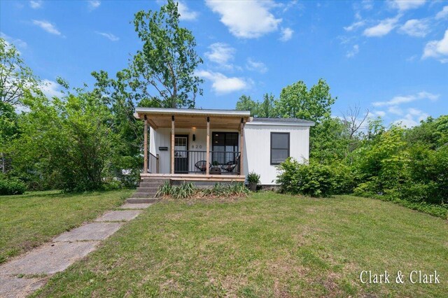 820 Hackett St, Ionia, MI 48846 - view of front of house featuring covered porch and a front yard