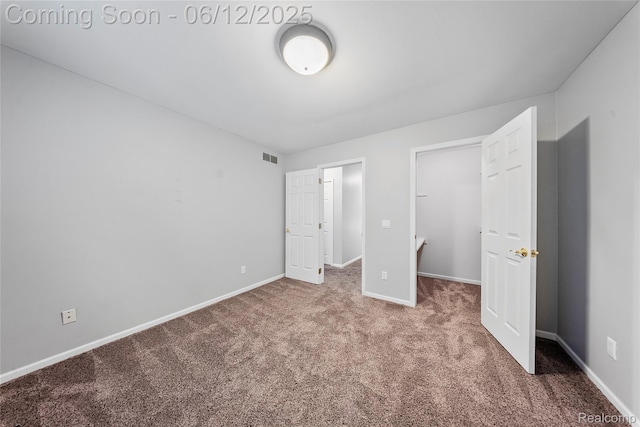 8487 Sherwood Dr, Grosse Ile, MI 48138 - unfurnished bedroom featuring carpet, baseboards, and a walk in closet