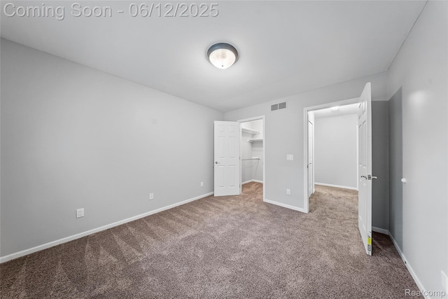 8487 Sherwood Dr, Grosse Ile, MI 48138 - unfurnished bedroom featuring carpet floors, a walk in closet, baseboards, and a closet
