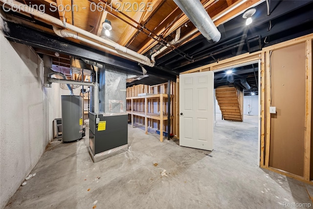 8487 Sherwood Dr, Grosse Ile, MI 48138 - unfinished basement with gas water heater, heating unit, and stairway