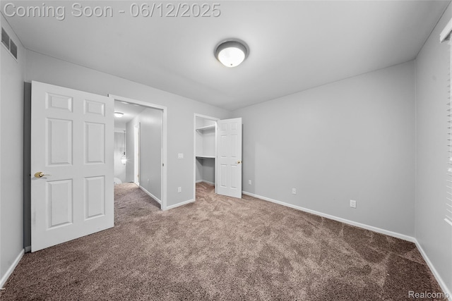 8487 Sherwood Dr, Grosse Ile, MI 48138 - unfurnished bedroom featuring carpet, baseboards, a walk in closet, and a closet