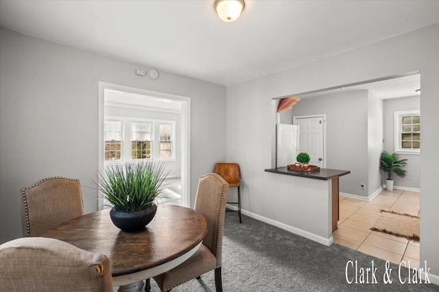 1714 Kalamazoo Ave SE, Grand Rapids, MI 49507 - dining area with baseboards, light tile patterned floors, and light carpet