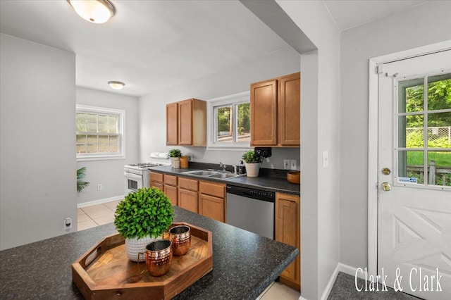 1714 Kalamazoo Ave SE, Grand Rapids, MI 49507 - kitchen with dishwasher, white gas range, a sink, and healthy amount of natural light