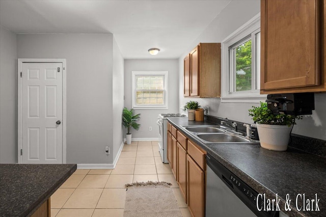 1714 Kalamazoo Ave SE, Grand Rapids, MI 49507 - kitchen with a sink, range with gas stovetop, brown cabinets, dishwasher, and dark countertops