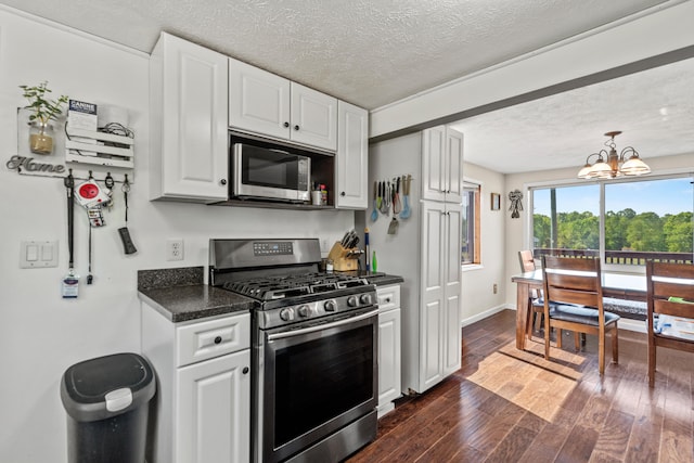 5886 13 Mile Rd, Remus, MI 49340 - kitchen featuring appliances with stainless steel finishes, a textured ceiling, white cabinetry, dark wood-type flooring, and a chandelier