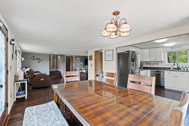 5886 13 Mile Rd, Remus, MI 49340 - dining area with dark wood-style flooring, a chandelier, and a textured ceiling