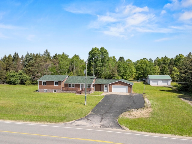 5886 13 Mile Rd, Remus, MI 49340 - single story home featuring a front lawn, a forest view, and driveway