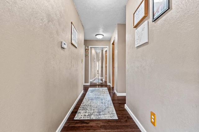 5886 13 Mile Rd, Remus, MI 49340 - hallway with wood finished floors, a textured wall, baseboards, and a textured ceiling