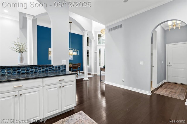 5624 Knob Hill Cir, Clarkston, MI 48348 - kitchen with a chandelier, ornate columns, arched walkways, and crown molding