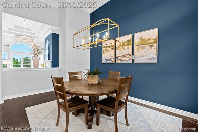 5624 Knob Hill Cir, Clarkston, MI 48348 - dining room with a chandelier, a raised ceiling, and wood finished floors