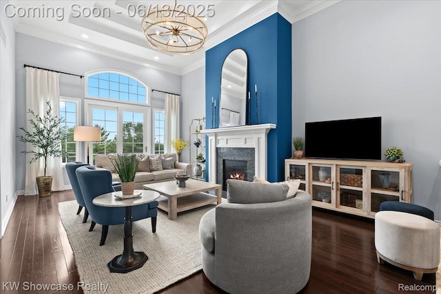 5624 Knob Hill Cir, Clarkston, MI 48348 - living area featuring a high ceiling, ornamental molding, wood-type flooring, a lit fireplace, and a chandelier