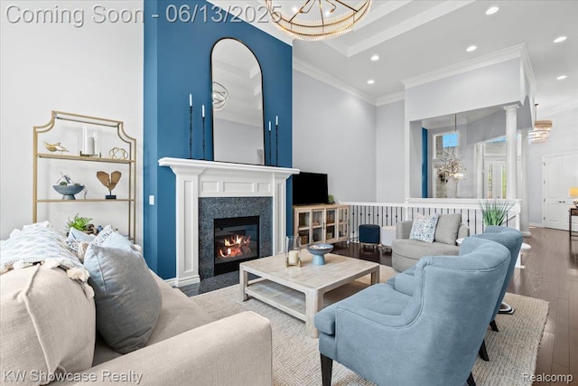 5624 Knob Hill Cir, Clarkston, MI 48348 - living room featuring ornamental molding, recessed lighting, wood finished floors, a chandelier, and a high end fireplace