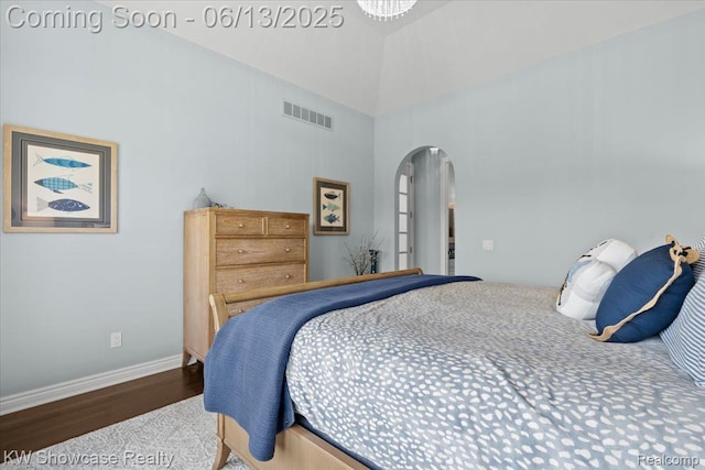 5624 Knob Hill Cir, Clarkston, MI 48348 - bedroom featuring arched walkways, wood finished floors, and a towering ceiling