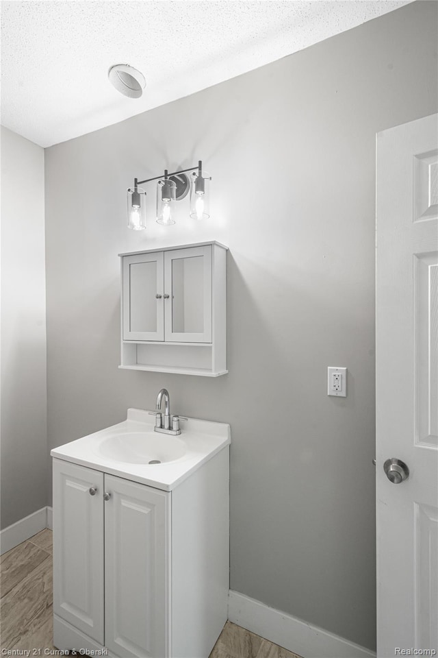 3054 Cadillac Blvd, Redford, MI 48214 - bathroom featuring vanity, baseboards, and a textured ceiling