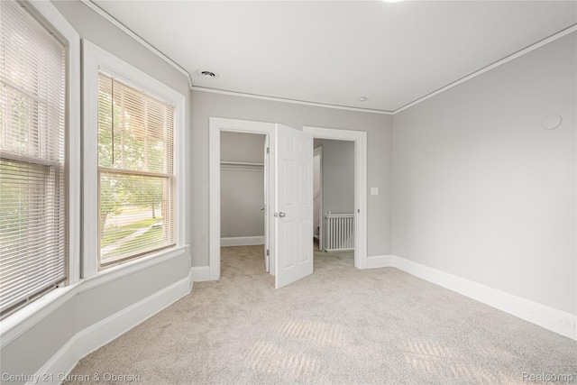 3054 Cadillac Blvd, Redford, MI 48214 - unfurnished bedroom featuring carpet, crown molding, baseboards, a spacious closet, and a closet