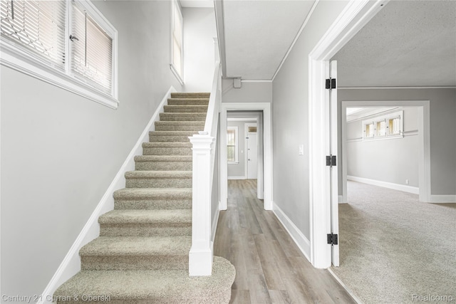 3054 Cadillac Blvd, Redford, MI 48214 - stairs with baseboards, wood finished floors, and crown molding