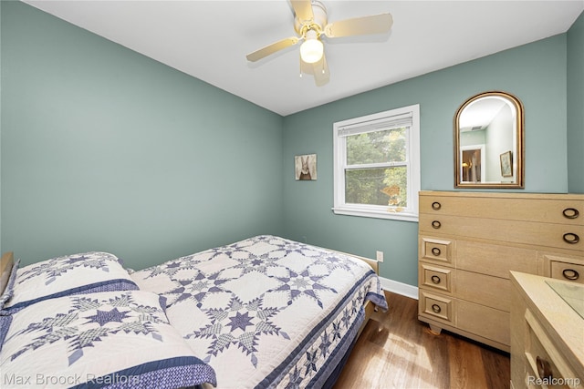 1982 E Coon Lake Rd, Howell, MI 48843 - bedroom with dark wood-type flooring and ceiling fan