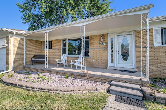 2095 Garry Dr, Troy, MI 48083 - entrance to property featuring covered porch, brick siding, and an attached garage