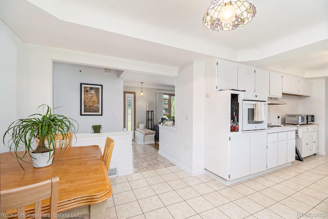 2095 Garry Dr, Troy, MI 48083 - kitchen featuring white appliances, light tile patterned floors, white cabinetry, light countertops, and under cabinet range hood