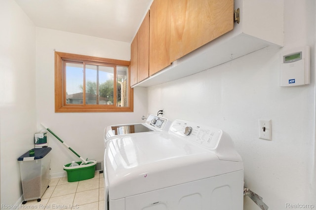 2095 Garry Dr, Troy, MI 48083 - laundry area with cabinet space, washer and clothes dryer, and light tile patterned flooring