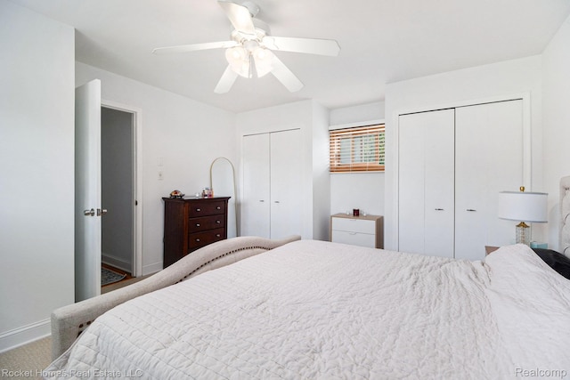 2095 Garry Dr, Troy, MI 48083 - bedroom featuring two closets, a ceiling fan, and carpet floors