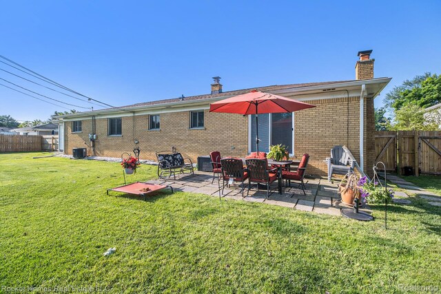 2095 Garry Dr, Troy, MI 48083 - back of property with a chimney, a patio area, a fenced backyard, and brick siding
