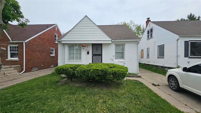 19610 Westphalia St, Detroit, MI 48205 - bungalow-style home featuring brick siding and a front lawn