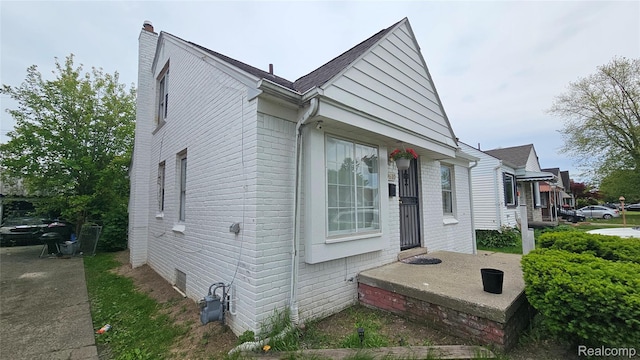 19610 Westphalia St, Detroit, MI 48205 - view of front of property featuring a chimney and brick siding