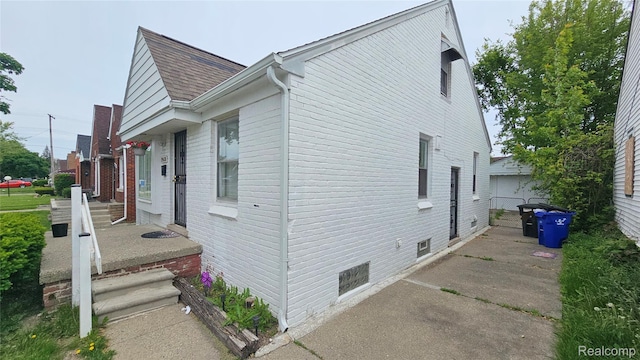 19610 Westphalia St, Detroit, MI 48205 - view of side of property with roof with shingles and a detached garage
