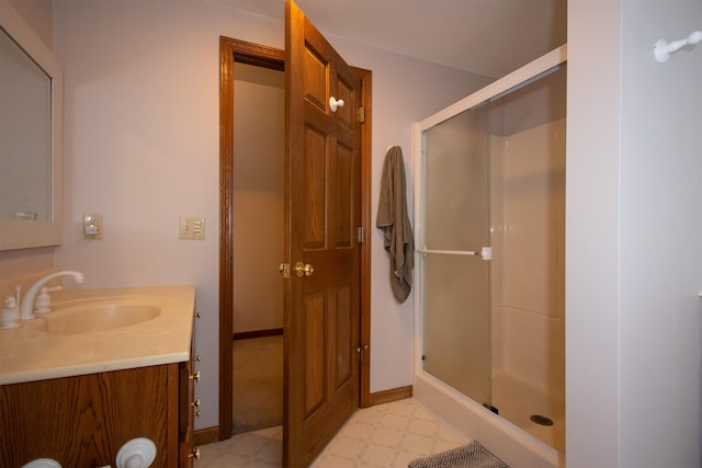 10926 Gorsline Rd, Battle Creek, MI 49014 - bathroom featuring a stall shower, vanity, tile patterned floors, and baseboards