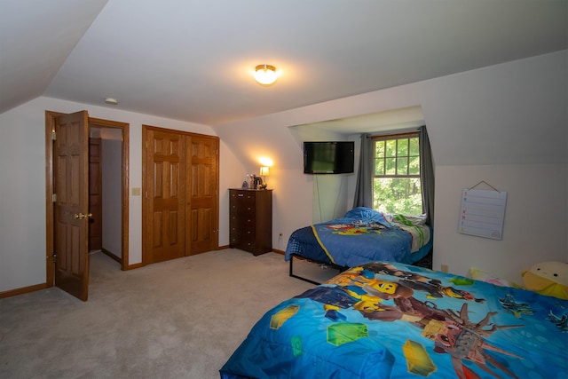 10926 Gorsline Rd, Battle Creek, MI 49014 - bedroom with lofted ceiling, light colored carpet, a closet, and baseboards