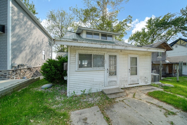 194 Pentecost Hwy, Onsted, MI 49265 - view of front of house featuring metal roof, a front yard, and ac unit