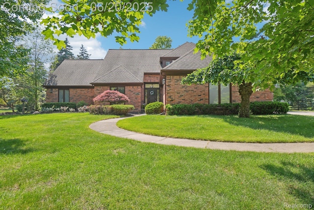 4541 Rivers Edge, Troy, MI 48098 - view of front of property featuring brick siding, a front lawn, and roof with shingles