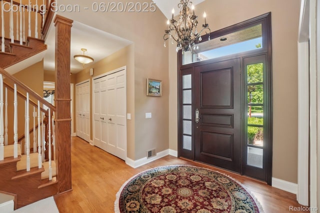 4541 Rivers Edge, Troy, MI 48098 - entryway featuring a chandelier, wood finished floors, and stairs