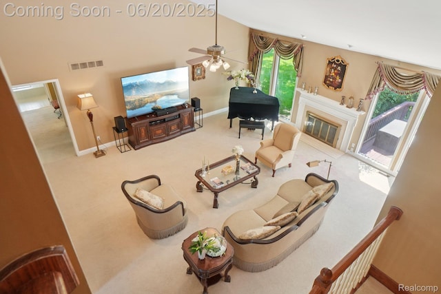 4541 Rivers Edge, Troy, MI 48098 - living area featuring ceiling fan, a glass covered fireplace, carpet, and a towering ceiling