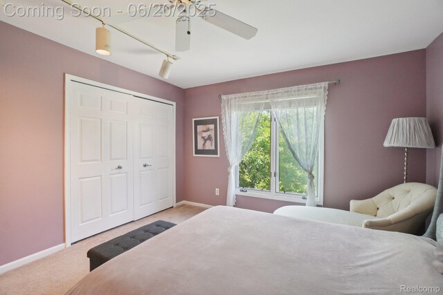 4541 Rivers Edge, Troy, MI 48098 - carpeted bedroom with rail lighting, a closet, and ceiling fan