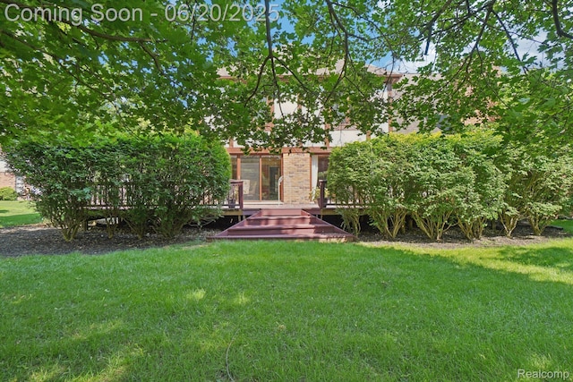 4541 Rivers Edge, Troy, MI 48098 - view of front of house with a front yard, a wooden deck, and brick siding
