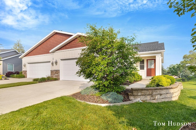 158 Brewer Park Cir, Grand Rapids, MI 49548 - view of front of home with driveway, a front yard, a garage, stone siding, and board and batten siding