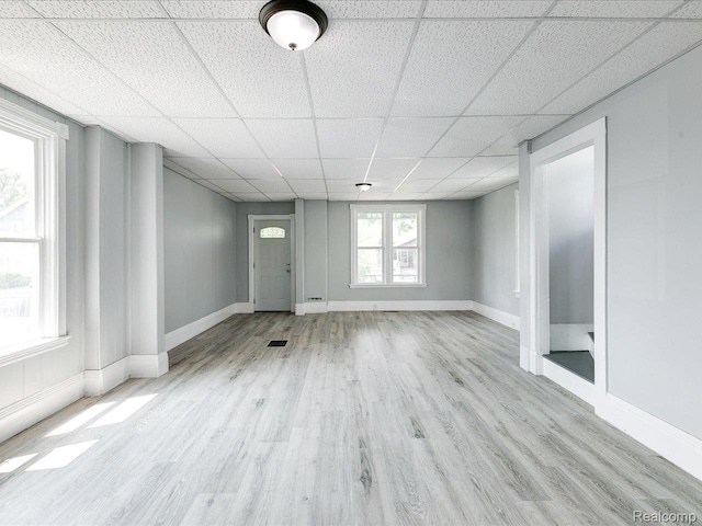 718 Superior St, Port Huron, MI 48060 - unfurnished living room with wood finished floors, a drop ceiling, and baseboards