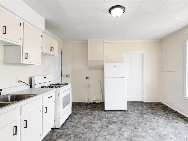 718 Superior St, Port Huron, MI 48060 - kitchen featuring white appliances, light countertops, white cabinets, a sink, and baseboards